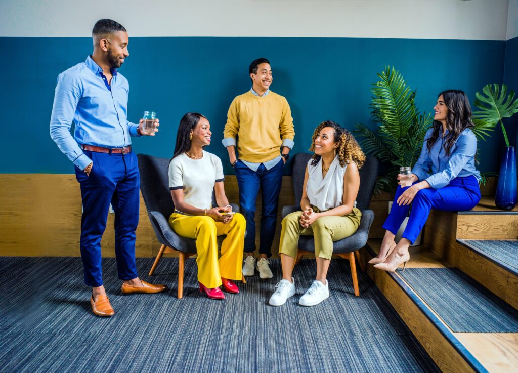 Group of people sitting and standng having a conversation