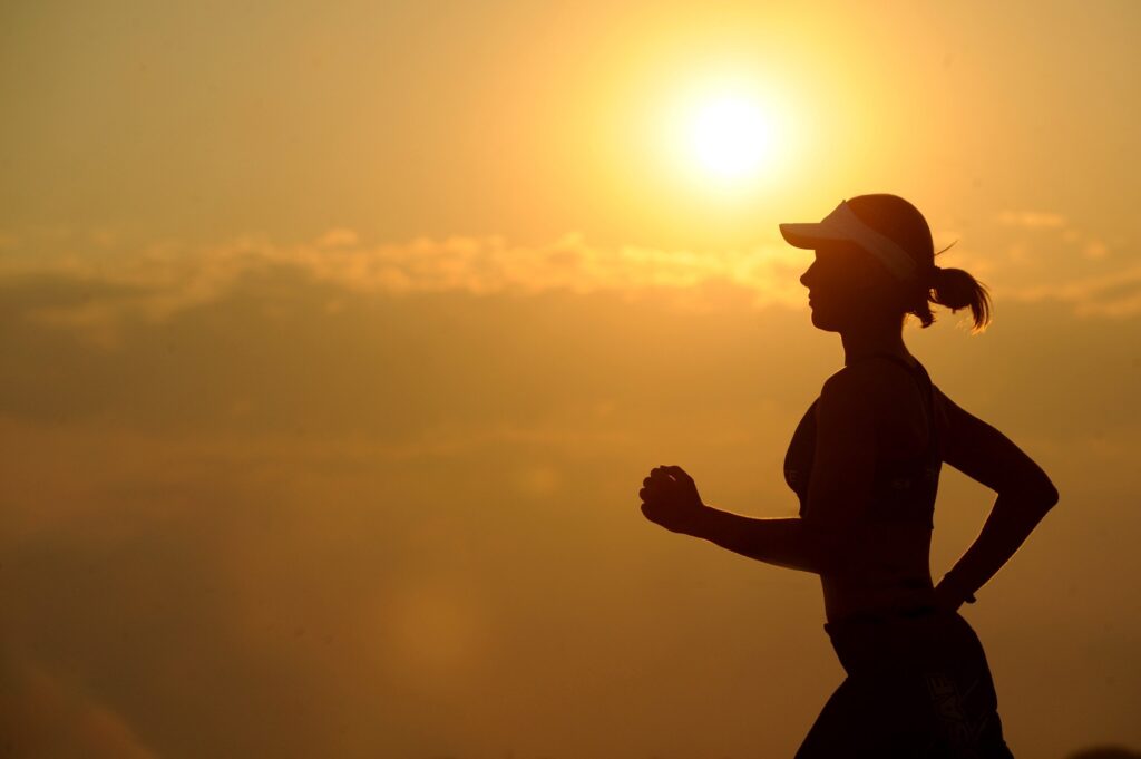 Woman running during sunrise
